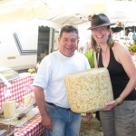 Heather with a market vendor and a (fake) 40kg wheel of Cantal
